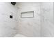 This shower features sleek marble tiling, modern fixtures, and built in shelf at 2724 Natalie Ave, Las Vegas, NV 89121