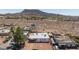 Aerial shot showcasing the house with mature trees and a mountain view at 335 W Basic Rd, Henderson, NV 89015