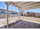 Backyard with covered patio, featuring brick walls and a wooden fence at 335 W Basic Rd, Henderson, NV 89015