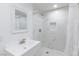 All-white bathroom with tiled shower, and a modern vanity at 335 W Basic Rd, Henderson, NV 89015