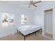 Bright bedroom with two windows, a ceiling fan, and a sliding door closet with carpeted floors at 335 W Basic Rd, Henderson, NV 89015
