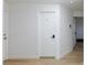 Hallway with wood-look flooring and white doors, promoting a clean aesthetic at 335 W Basic Rd, Henderson, NV 89015