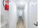 A bright hallway with multiple doors and a mounted fire extinguisher at 335 W Basic Rd, Henderson, NV 89015
