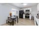 Bright kitchen with white cabinets, stainless steel appliances, and a dining area at 335 W Basic Rd, Henderson, NV 89015