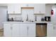 Bright kitchen with stainless steel dishwasher and white cabinets at 335 W Basic Rd, Henderson, NV 89015