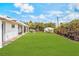 Spacious backyard showcasing a large lawn and additional white storage shed in background at 343 W Basic Rd, Henderson, NV 89015