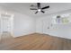 Clean bedroom featuring neutral colors, wood floors, a ceiling fan, and bright natural light at 343 W Basic Rd, Henderson, NV 89015