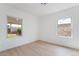 A bright bedroom featuring neutral paint and flooring, and natural light from two windows at 343 W Basic Rd, Henderson, NV 89015