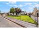 Charming home with a fenced front yard, mature trees, and a well-manicured lawn at 343 W Basic Rd, Henderson, NV 89015