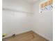 A small room or closet with white walls and wood-look flooring, showing simple storage at 343 W Basic Rd, Henderson, NV 89015