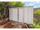 White storage shed surrounded by lush foliage with brick-lined mulch beds at 343 W Basic Rd, Henderson, NV 89015