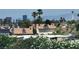 Residential view of neighborhood rooftops, palm trees, city buildings and Stratosphere in distance at 3453 Del Marino Dr, Las Vegas, NV 89121