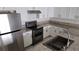Modern kitchen featuring stainless steel appliances, granite countertops, and white cabinets at 3453 Del Marino Dr, Las Vegas, NV 89121