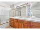 Bathroom vanity with oak cabinets and large mirror at 3629 Laguna Verde Way, Las Vegas, NV 89121