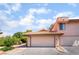 A charming home exterior shows a two-car garage and a red-tiled roof under blue skies at 3629 Laguna Verde Way, Las Vegas, NV 89121