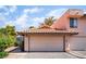 A home exterior with a two-car garage and a red-tiled roof against a backdrop of blue skies and greenery at 3629 Laguna Verde Way, Las Vegas, NV 89121