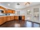 Traditional kitchen with wood cabinets, white countertops, black appliances, and hardwood floors at 3629 Laguna Verde Way, Las Vegas, NV 89121