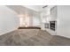 Spacious living room with plush carpet, fireplace, bright light, and open floor plan at 3629 Laguna Verde Way, Las Vegas, NV 89121