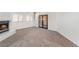 The carpeted living room features a fireplace, large windows, and sliding doors, showcasing a bright and open space at 3629 Laguna Verde Way, Las Vegas, NV 89121
