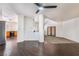 Bright living room featuring hardwood floors, high ceilings with a ceiling fan and sliding glass doors at 3629 Laguna Verde Way, Las Vegas, NV 89121