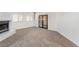 The carpeted living room features a fireplace, large windows, and sliding doors, showcasing a bright and open space at 3629 Laguna Verde Way, Las Vegas, NV 89121