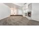 Spacious living room with plush carpet, fireplace, bright light, and open floor plan at 3629 Laguna Verde Way, Las Vegas, NV 89121