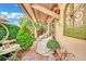 Cozy covered patio with brick floor, seating, and garden decor for outdoor relaxation at 3741 Via Gaetano, Henderson, NV 89052