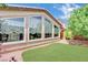The backyard has a well-kept lawn and sizable windows that let in plenty of natural light at 3741 Via Gaetano, Henderson, NV 89052