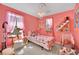 Pink bedroom featuring a colorful bedspread, decorative accents, and bright, cheery ambiance at 3741 Via Gaetano, Henderson, NV 89052