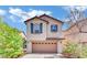 Charming two-story home featuring a well-manicured lawn, a two-car garage, and decorative shutters at 3741 Via Gaetano, Henderson, NV 89052