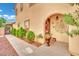 Charming home exterior featuring an arched entry and well-manicured landscaping at 3741 Via Gaetano, Henderson, NV 89052