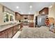 Large kitchen with island, stainless appliances, breakfast bar, and stone countertops at 3741 Via Gaetano, Henderson, NV 89052