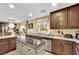 Bright kitchen featuring an island, stainless steel appliances, and granite counters at 3741 Via Gaetano, Henderson, NV 89052
