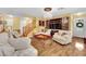 Spacious living room with hardwood floors, chandelier, and a staircase leading to the upper level at 3741 Via Gaetano, Henderson, NV 89052