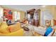 Cozy living room featuring a fireplace, comfortable seating, and a large decorative mural at 3741 Via Gaetano, Henderson, NV 89052