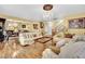 Bright, open-concept living room with hardwood floors, chandelier, and a seamless connection to the dining area at 3741 Via Gaetano, Henderson, NV 89052