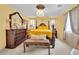 Elegant main bedroom with a four-poster bed, decorative mirror, and ample natural light at 3741 Via Gaetano, Henderson, NV 89052