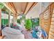 Inviting covered patio with outdoor seating, decorative plants, and a private garden view at 3741 Via Gaetano, Henderson, NV 89052