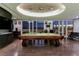Stylish game room with a classic billiard table, dark wood floors, and stunning city views at 3750 S Las Vegas Blvd # 4507, Las Vegas, NV 89158