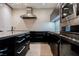 Modern kitchen featuring sleek black cabinets and stainless steel appliances, including an island at 3750 S Las Vegas Blvd # 4507, Las Vegas, NV 89158