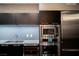 Modern kitchen featuring stainless steel appliances including oven and wine cooler and dark cabinets at 3750 S Las Vegas Blvd # 4507, Las Vegas, NV 89158