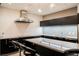 Modern kitchen featuring sleek black cabinets and stainless steel appliances, with an island at 3750 S Las Vegas Blvd # 4507, Las Vegas, NV 89158
