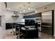 Modern kitchen features dark cabinets, stainless steel appliances, and bar stool seating at the counter at 3750 S Las Vegas Blvd # 4507, Las Vegas, NV 89158
