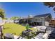 Spacious backyard with well-maintained lawn, covered patio, and ample seating at 4492 Rita Dr, Las Vegas, NV 89121