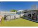 Backyard featuring pool, covered dining area and synthetic grass, perfect for outdoor living and entertainment at 4492 Rita Dr, Las Vegas, NV 89121