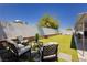 Relaxing backyard seating area featuring synthetic grass and a privacy wall perfect for outdoor entertainment at 4492 Rita Dr, Las Vegas, NV 89121