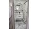 Updated bathroom showcasing marble-style tiling, a vanity with modern fixtures, and a large mirror at 4492 Rita Dr, Las Vegas, NV 89121