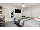 Bedroom featuring a dark wood bed, flat screen TV, and white closet doors at 4492 Rita Dr, Las Vegas, NV 89121