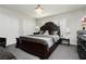 Elegant bedroom featuring a dark wood bed, crystal chandelier, and neutral décor at 4492 Rita Dr, Las Vegas, NV 89121