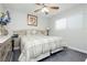 Calm bedroom offers neutral tones, a ceiling fan, and plenty of natural light from the window at 4492 Rita Dr, Las Vegas, NV 89121